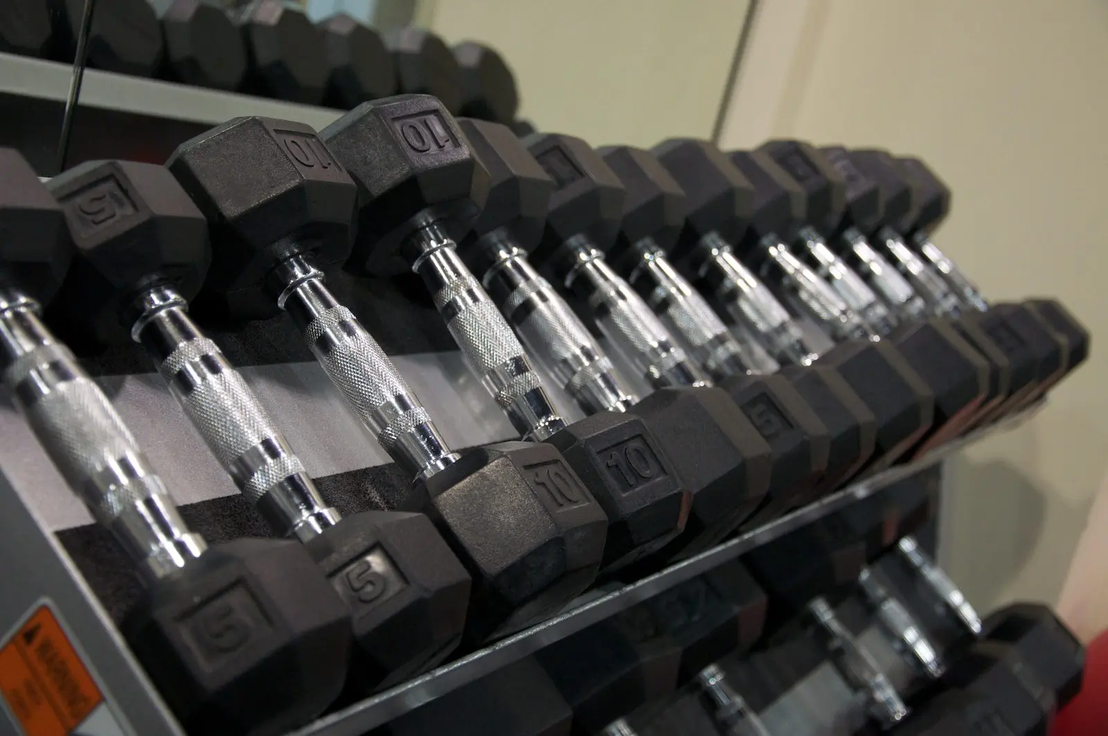 black and silver dumbbells on rack